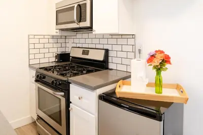 a kitchen with a stove and a vase of flowers at Cozy Koreatown/Hollywood 2 Bedroom in Los Angeles