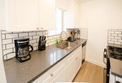 a kitchen with a sink and a counter top at Cozy Koreatown/Hollywood 2 Bedroom in Los Angeles