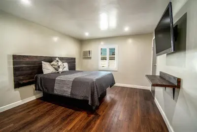 a bedroom with a bed and a television in it at ERTH INN by AGA- Bell Garden in Bell Gardens