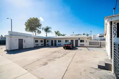 a building with a car parked in a parking lot at ERTH INN by AGA- Bell Garden in Bell Gardens
