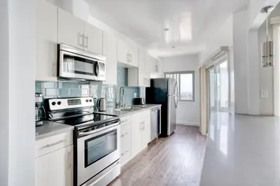 a kitchen with white cabinets and stainless steel appliances at Hollywood 1BR w Pool WD Gym nr Metro LAX-867 in Los Angeles