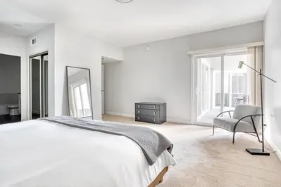 a white bedroom with a bed and a chair at Hollywood 1BR w Pool WD Gym nr Metro LAX-867 in Los Angeles