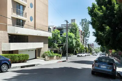 a street with cars parked on the side of a building at Hollywood 1BR w Pool WD Gym nr Metro LAX-867 in Los Angeles