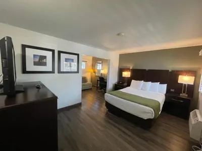 a hotel room with a bed and a television at Hi View Inn & Suites in Manhattan Beach