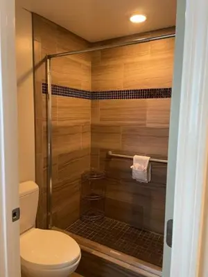 a bathroom with a shower with a toilet at Hi View Inn & Suites in Manhattan Beach