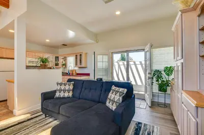a living room with a blue couch and a kitchen at Luxe Pasadena Casita with Fireplace and Grill in Pasadena