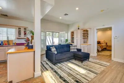 a living room with a blue couch and a kitchen at Luxe Pasadena Casita with Fireplace and Grill in Pasadena