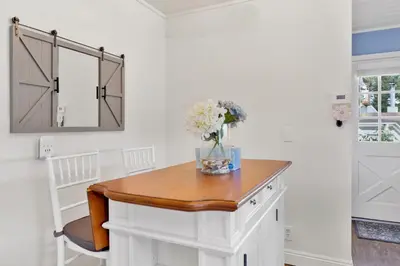 a white room with a table and a mirror at North Shore Chalet by Big Bear Vacations Lakeside Fawnskin Estate Boat Dock Lake Access in Fawnskin
