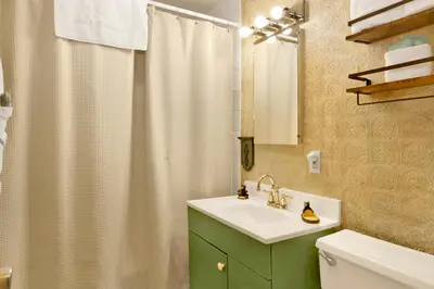 a bathroom with a green cabinet and a sink at Pine Cone Cottage by Big Bear Vacations Adorable Walk To Lake Furnished Chalet in Big Bear Lake
