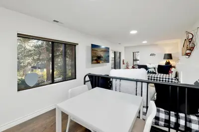 a room with a balcony with a table and chairs at Soaring Pines by Big Bear Vacations Central Cozy Estate Chalet in Big Bear Lake
