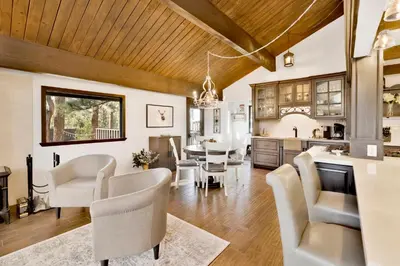a kitchen and dining room with a table and chairs at Soaring Pines by Big Bear Vacations Central Cozy Estate Chalet in Big Bear Lake