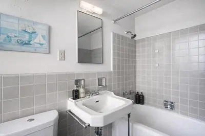 a bathroom with a sink and a toilet and a mirror at Spacious 2 Bedroom 2 Bathroom Unit Great Location in Los Angeles