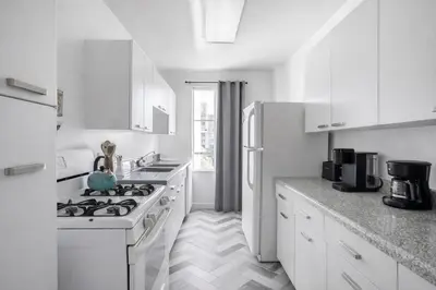 a white kitchen with a stove and a refrigerator at Spacious 2 Bedroom 2 Bathroom Unit Great Location in Los Angeles