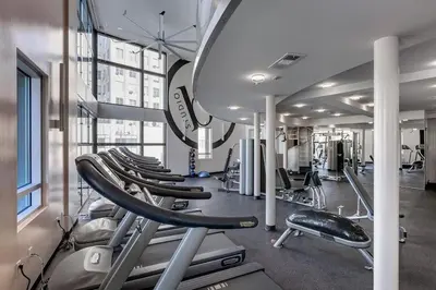 a gym with a row of treadmills and machines at Spacious 2 Bedroom 2 Bathroom Unit Great Location in Los Angeles