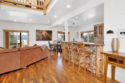 a living room with a couch and a bar at Cozy Lakeview Hideaway by Big Bear Vacations Amazing Fawnskin Log Cabin Chalet in Fawnskin