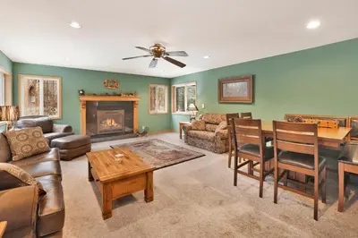 a living room filled with furniture and a fireplace at Fawnskin Log Cabin- Luxurious Group Log Cabin Estate- Hot Tub- Walk to Lake in Fawnskin