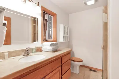 a bathroom with a sink and a toilet at Fawnskin Log Cabin- Luxurious Group Log Cabin Estate- Hot Tub- Walk to Lake in Fawnskin