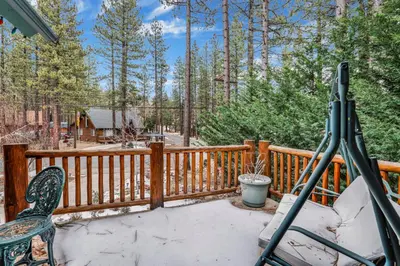 a deck with a chair and a telescope on it at Fawnskin Log Cabin- Luxurious Group Log Cabin Estate- Hot Tub- Walk to Lake in Fawnskin