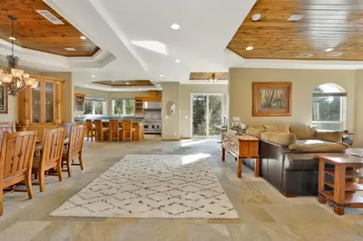 a living room with a couch and a table at Sunset Ridge Villa- Incredible Log Cabin Estate- Hot Tub- Game Tables- in Big Bear Lake