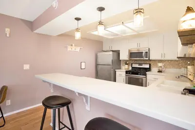 a kitchen with a white counter top and a sink at Brownie's Den- Modern Cozy Central Resort Condo in Big Bear Lake