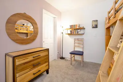 a room with a wooden dresser and a mirror at Brownie's Den- Modern Cozy Central Resort Condo in Big Bear Lake