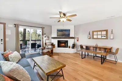 a living room with a couch and a fireplace at Brownie's Den- Modern Cozy Central Resort Condo in Big Bear Lake