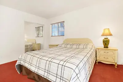 a bedroom with a bed and a lamp on a night stand at Cozy Summit- Cozy Central Resort Chalet- Minutes to Activities in Big Bear Lake