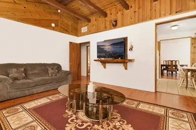 a living room with a couch and a glass table at Cozy Summit- Cozy Central Resort Chalet- Minutes to Activities in Big Bear Lake