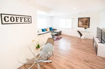 a living room with a glass table and a couch at Modern Furnished 1-Bedroom with Free Parking in Koreatown close to DT LA in Los Angeles