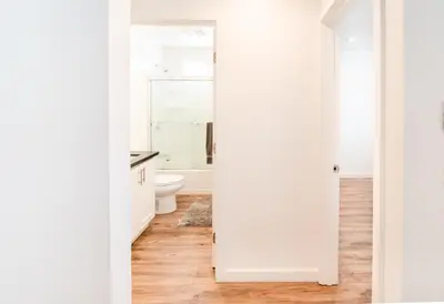 a white bathroom with a toilet and a sink at Modern Furnished 1-Bedroom with Free Parking in Koreatown close to DT LA in Los Angeles