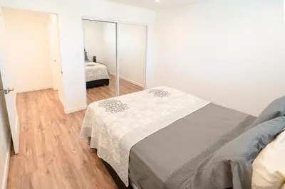 a bedroom with a bed and a mirror at Modern Furnished 1-Bedroom with Free Parking in Koreatown close to DT LA in Los Angeles