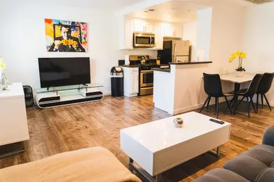 a living room with a table and a kitchen at Cozy Koreatown 1 Bedroom Modern Furnished Free Parking in Los Angeles