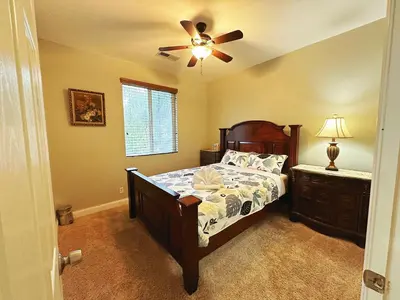 a bedroom with a bed and a ceiling fan at Cozy And Comfortable #202 Room in Corona