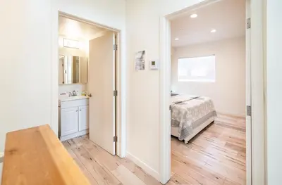 a bedroom with a bed and a door leading to a bathroom at Hollywood 3Bedrooms Stylish Loft with 2 Parking in Los Angeles