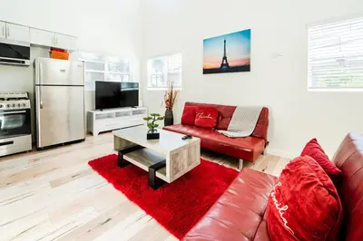 a living room with a red couch and a red rug at Hollywood 3Bedrooms Stylish Loft with 2 Parking in Los Angeles