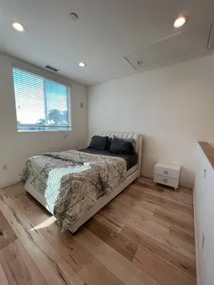 a bedroom with a bed and a wooden floor at Modern One-Bed Loft in Hollywood Sign View & Free Parking in Los Angeles