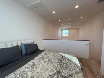 a bedroom with a king sized bed and a window at Modern One-Bed Loft in Hollywood Sign View & Free Parking in Los Angeles