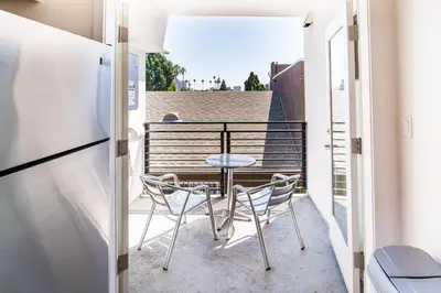 a small balcony with a table and chairs on it at Chic 1-Bed Hollywood Loft Iconic Sign Views & Private Parking in Los Angeles