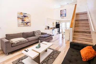 a living room with a couch and a table at Chic 1-Bed Hollywood Loft Iconic Sign Views & Private Parking in Los Angeles