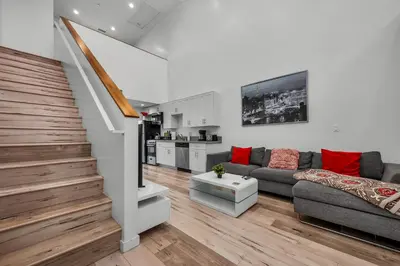 a living room with a couch and a staircase at New 1 Bedroom Loft with View of Hollywood Sign in Los Angeles