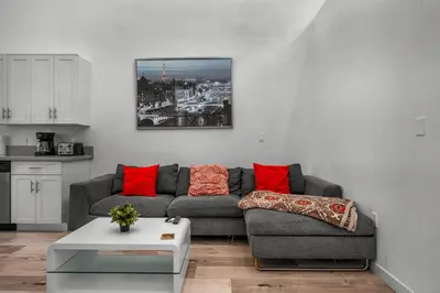 a living room with a gray couch and red pillows at New 1 Bedroom Loft with View of Hollywood Sign in Los Angeles