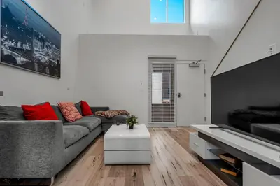 a living room with a gray couch and red pillows at New 1 Bedroom Loft with View of Hollywood Sign in Los Angeles