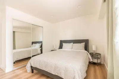 a white bedroom with a large bed and a mirror at 30 PCT OFF! Malibu Villa, Ocean View, Beach, Hiking in Malibu