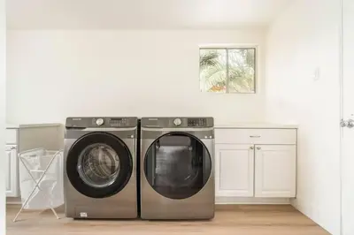 a laundry room with two washing machines and a window at 30 PCT OFF! Malibu Villa, Ocean View, Beach, Hiking in Malibu
