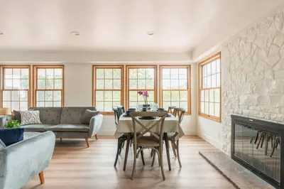 a living room with a table and a fireplace at 30 PCT OFF! Malibu Villa, Ocean View, Beach, Hiking in Malibu
