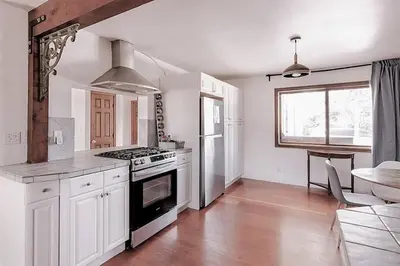 a kitchen with white cabinets and a stove top oven at Malibu Ocean Villa with King Bed, Hot Tub, Beach, BBQ in Malibu