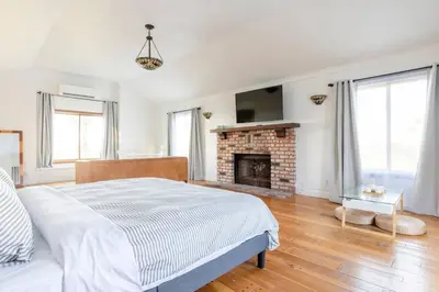 a white bedroom with a bed and a fireplace at 30 PCT OFF! Malibu Romantic Suite, Ocean View, Beach in Malibu