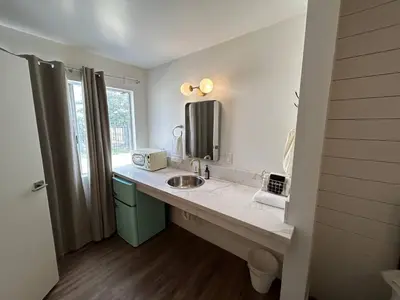 a bathroom with a sink and a mirror at Sierra Motor Lodge - A Sierra Blue Hotel in Mojave