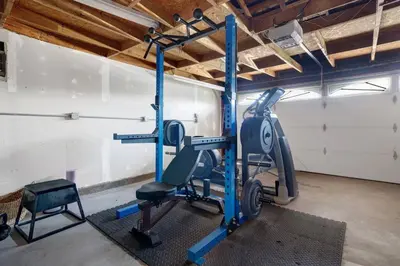 a gym with a tread machine in a room at Private Heated Pool Oasis/Disney/Retro Arcade/Gym in Placentia