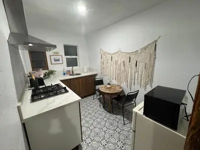 a kitchen with a stove and a sink and a table at Three Pines Cabins in Big Bear Lake